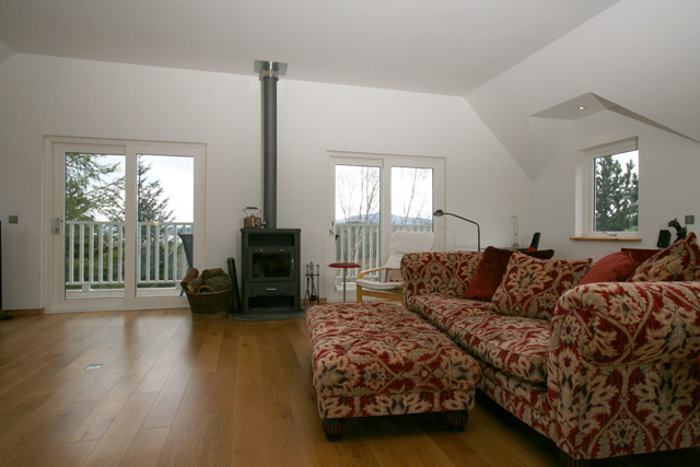 Lounge with wood burning stove and views to Loch Mhor
